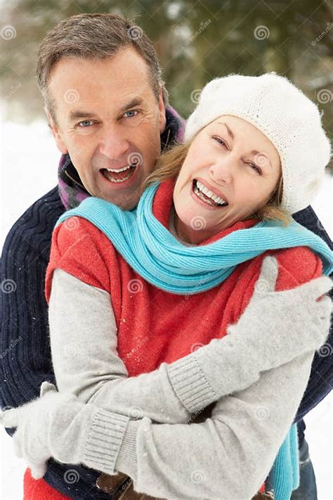 Senior Couple Standing Outside In Snowy Landscape Stock Photo Image