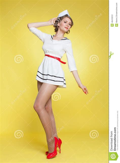 Beautiful Pin Up Girl Dressed A Sailor Posing On Yellow