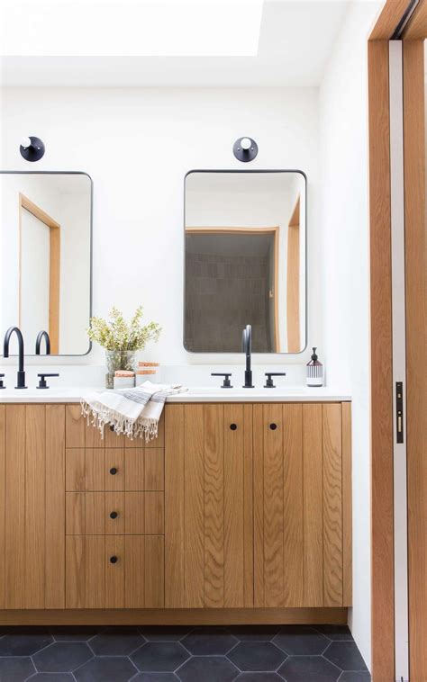 In this bathroom, the clear shower screen with the black windowed lines adds a dramatic feature while matching nicely with the mirror edge, tap fittings and towel rail. 10 of the Most Exciting Bathroom Design Trends for 2019