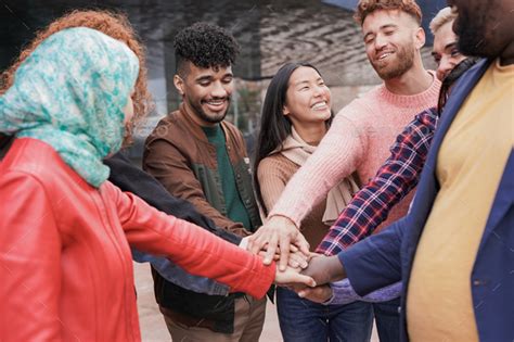 Group Of Young Multiracial People Stacking Hands Together Outdoor Stock