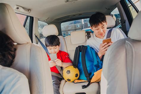 Chinese Kids Sitting In Backseat Stock Photo Download Image Now