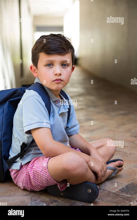 Boy Sitting On Corridor In School Stock Photo Alamy
