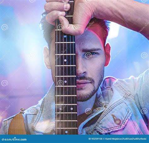 Portrait Of A Handsome Performer Holding A Guitar Stock Photo Image