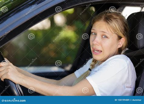 Young Beautiful Woman Scared And Stressed While Driving Car Stock Image