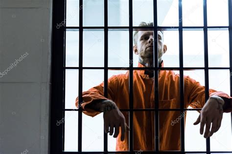 Prisoner Putting Hands Prison Bars — Stock Photo © Arturverkhovetskiy