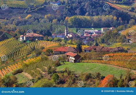 Small Village And Autumnal Vineyards In Piedmont Italy Stock Photo