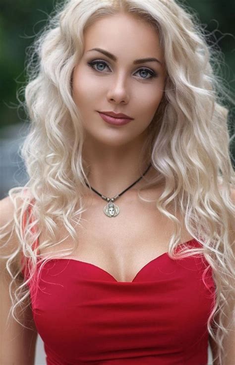 A Woman With Long Blonde Hair Wearing A Red Dress