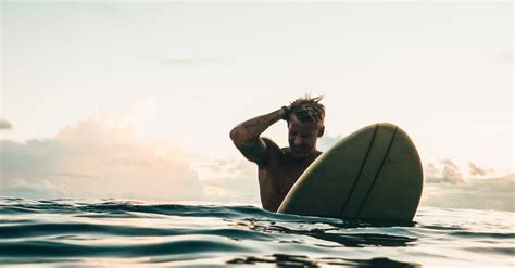 Man Holding White Surfboard · Free Stock Photo