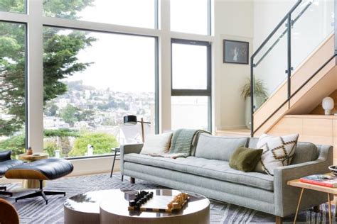 You'll love these amazing sunken living room ideas! Neutral Contemporary Living Room With Big Windows | HGTV