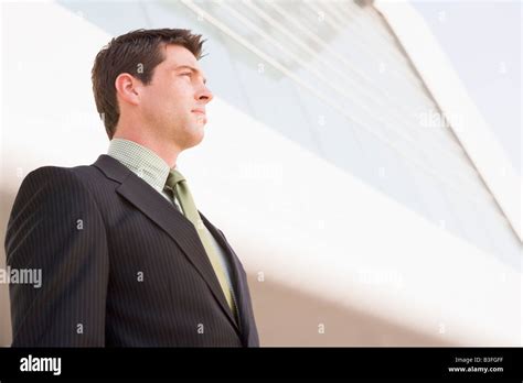 Businessman Standing Outdoors By Building Stock Photo Alamy