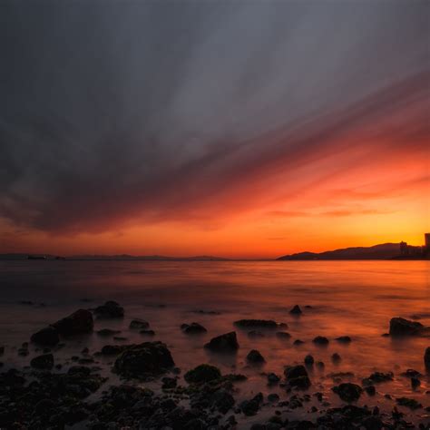 Download Wallpaper 2780x2780 Sea Sunset Stones Horizon Sky Coast