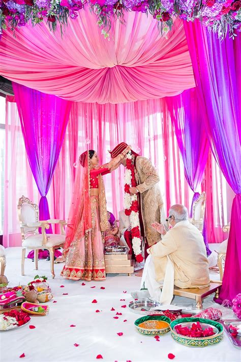 .than enough to have a traditional indian wedding in malaysia unless you plan an elaborate one. Ceremony Décor Photos - Bride Places Flower Garland Around ...