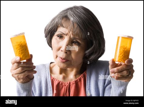 Confused Woman Holding Two Bottles Hi Res Stock Photography And Images