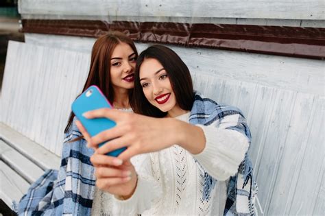 Free Photo Two Women Sit On The Bench And Do Selfie