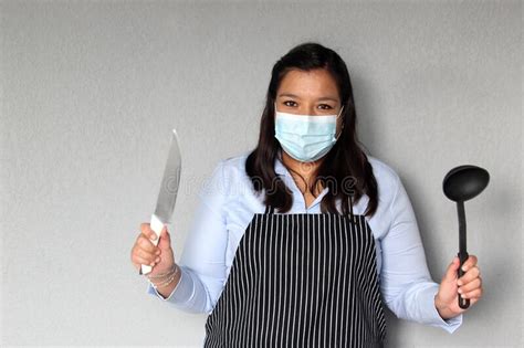 Latina Female Chef With Masks And Kitchen Utensils Working On The New