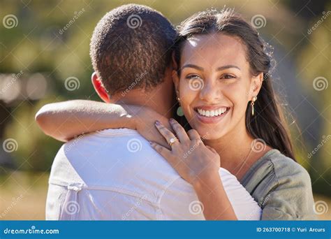love happiness and a couple hug in a park together nature sunshine and man and woman hugging