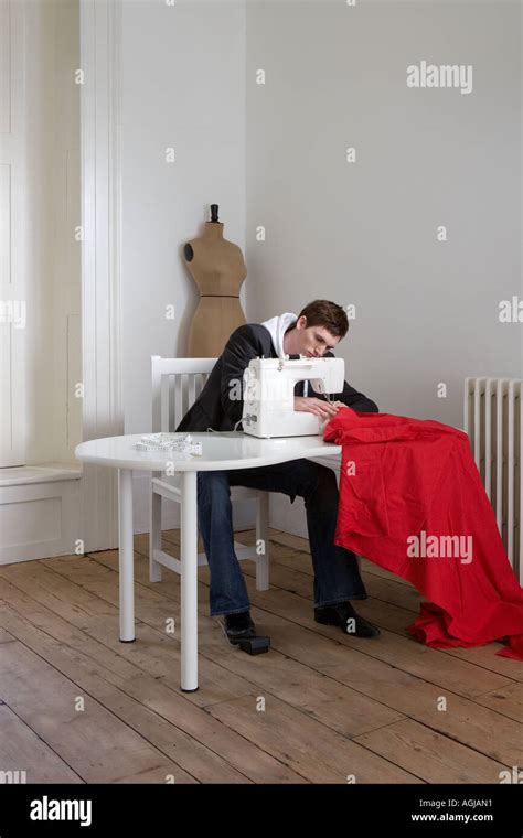 Man Sewing Red Fabric Stock Photo Alamy