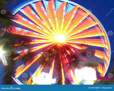 Amusement Park Ferris Wheel With Blurred Multicolored Lights Stock