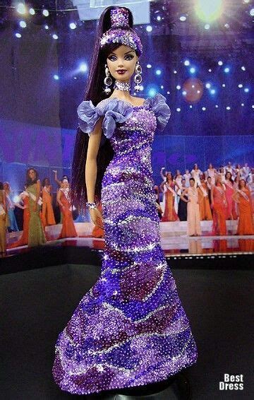 A Barbie Doll Wearing A Purple Dress And Tiara In Front Of A Stage