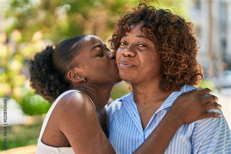 African American Women Mother And Daughter Hugging Each Other Kissing