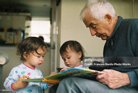 Grandfather Reading To Twin Granddaughters High Res Stock Photo Getty