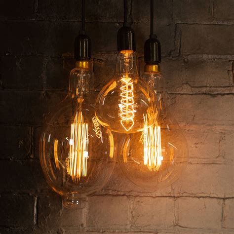 Three Light Bulbs Hanging From A Brick Wall