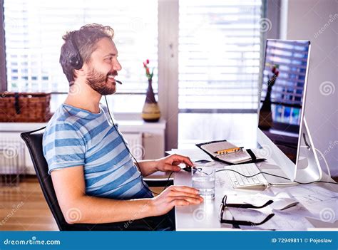 Man Sitting At Desk Working From Home On Computer Stock Image Image