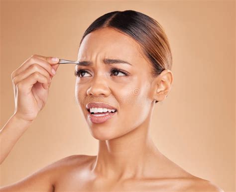 Beauty Pain And Eyebrows With Woman And Tweezers In Studio For Clean