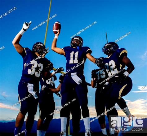 Teenage And Young Male American Football Team Celebrating Stock Photo
