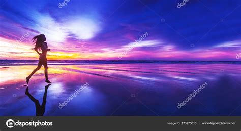 Woman Running On Beach At Sunset Stock Photo By Yellow2j 173275010