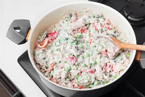 This classic tuna noodle casserole recipe combines tuna, egg noodles, cream of mushroom soup, peas, and cheddar cheese to make a creamy comforting casserole with a crunchy crumb topping. Classic Tuna Noodle Casserole Recipe Without Soup
