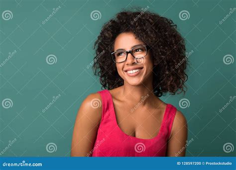 Beautiful African American Girl In Eyeglasses Looking Away Against Wall