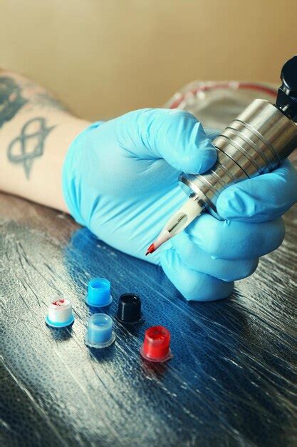Premium Photo Tattoo Artist At Work Close Up