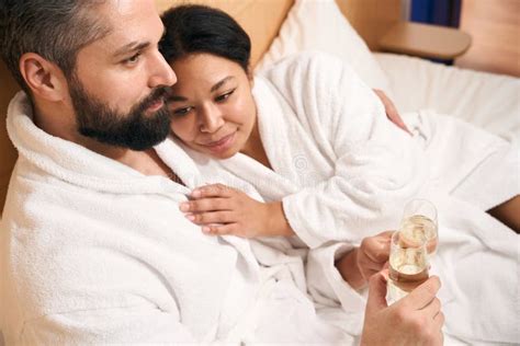 Interracial Couple Celebrating Their Anniversary In Hotel Room Stock