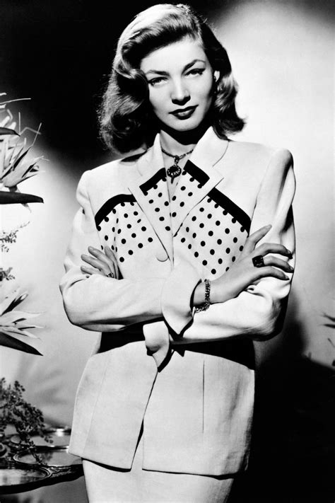 Black And White Photograph Of A Woman Wearing A Suit With Polka Dots On