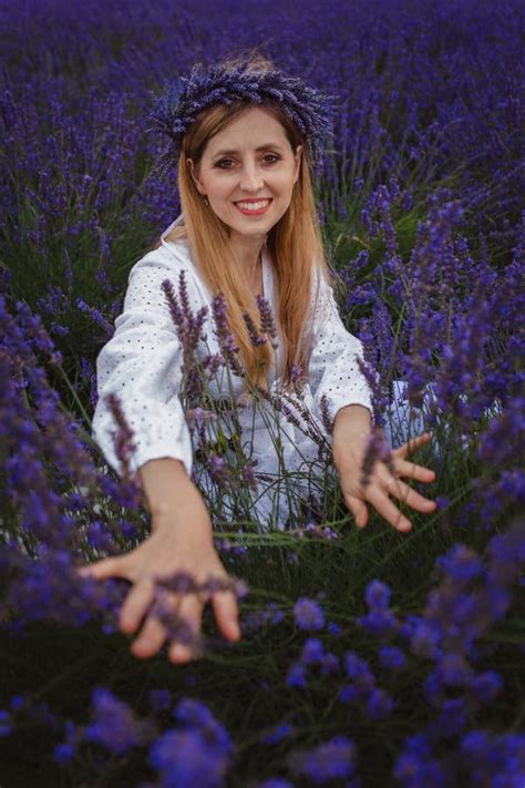 In The Picture A Smiling Woman Wearing A Head Wreath Is Spreading