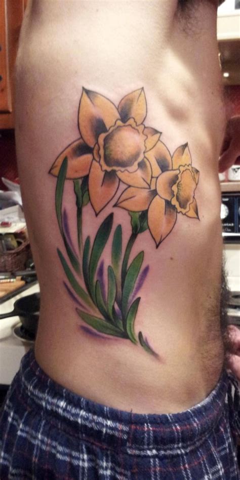 Daffodil symbol includes new beginning, forthrightness, forgiveness, trust, energy, radiance, friendship, life, vitality, honesty and rebirth. Daffodil Tattoos Designs, Ideas and Meaning | Tattoos For You