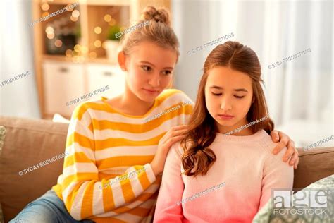 Teenage Girl Comforting Her Sad Friend At Home Stock Photo Picture