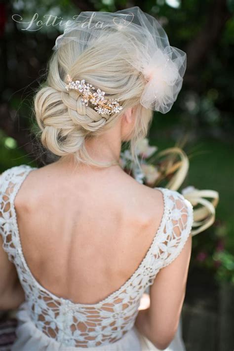 Add a pair of statement earrings? Floral Hairpiece Braided Low Bun Wedding Hairstyle - MODwedding