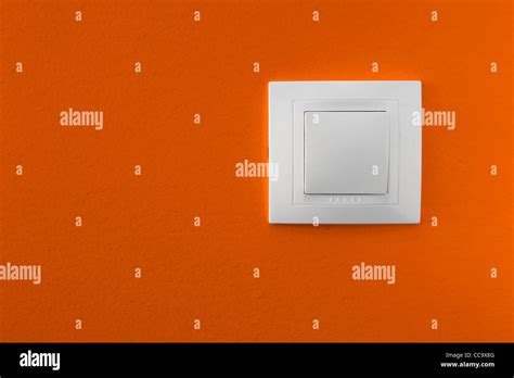 Simple Light Switch On A Orange Wall Stock Photo Alamy