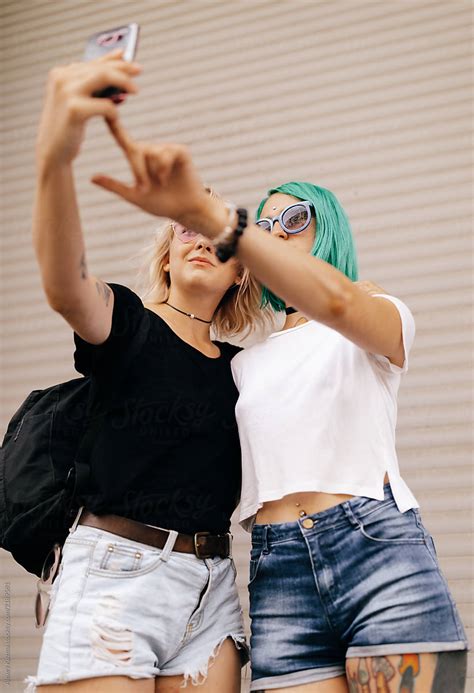 lesbian couple women making a selfie on the street by stocksy contributor alexey kuzma stocksy
