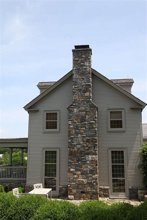 Sheds water away from chimney, keeps critters. Farmhouse. | Farm house colors, Stone chimney, House colors