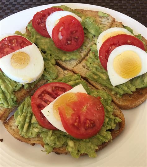 Avocado On Toast With Tomatoes Hard Boiled Egg And A Little Garlic