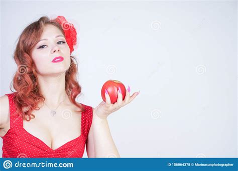 Young Pin Up Girl Holding Red Apple In Her Hand Stock