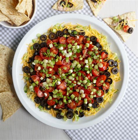Taco Dip Combines Salsa And Sour Cream And Is Topped With Fresh Veggies
