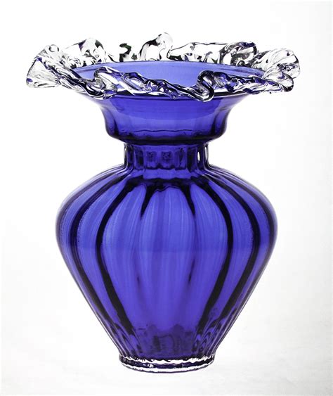 A Purple Glass Vase Sitting On Top Of A White Table