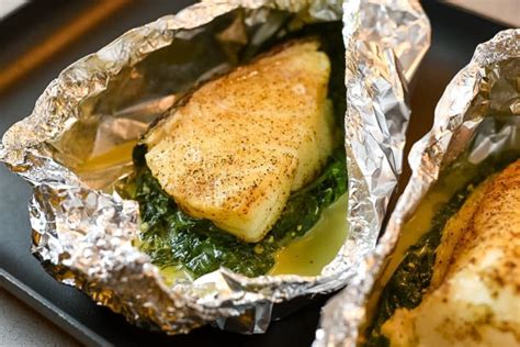 Baking This Delicious Chilean Sea Bass In Foil Along With Garlic Cream Spinach Served Topped