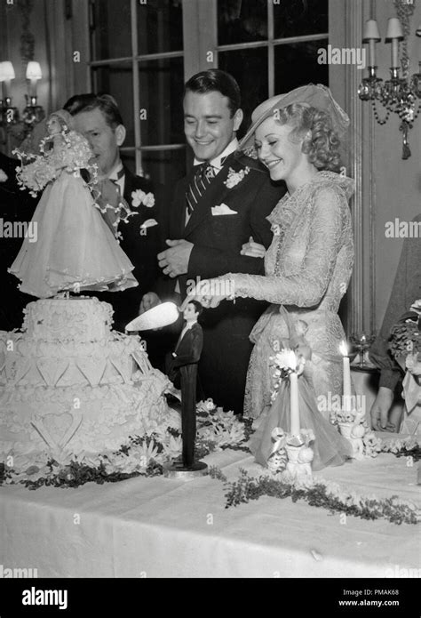 Ginger Rogers And Lew Ayres Cutting Their Cake On Their Wedding Day At