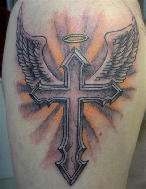 An elaborate tattoo utilizing wings and cross images. 50+ Cross Tattoo Designs To Show Your Faith - Tats 'n' Rings