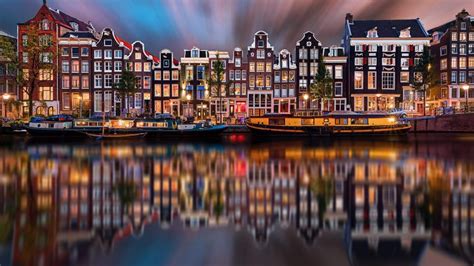 Colorful Houses At Amstel River At Night Amsterdam North Holland